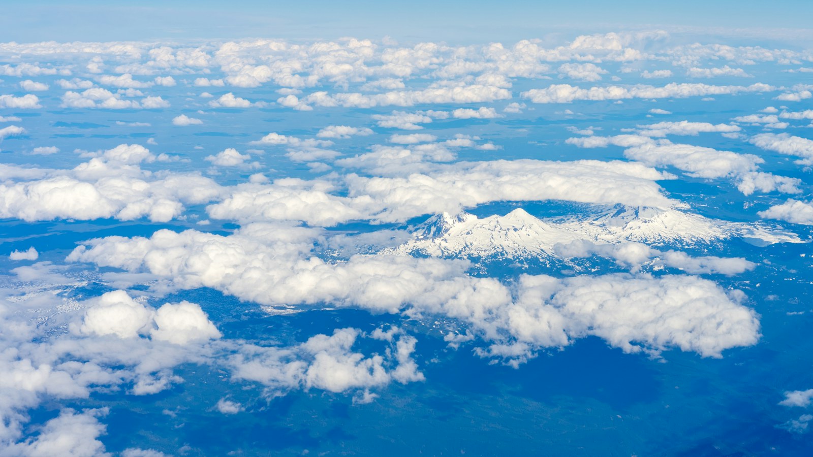 Aerial cloudscape above a mountain horizon